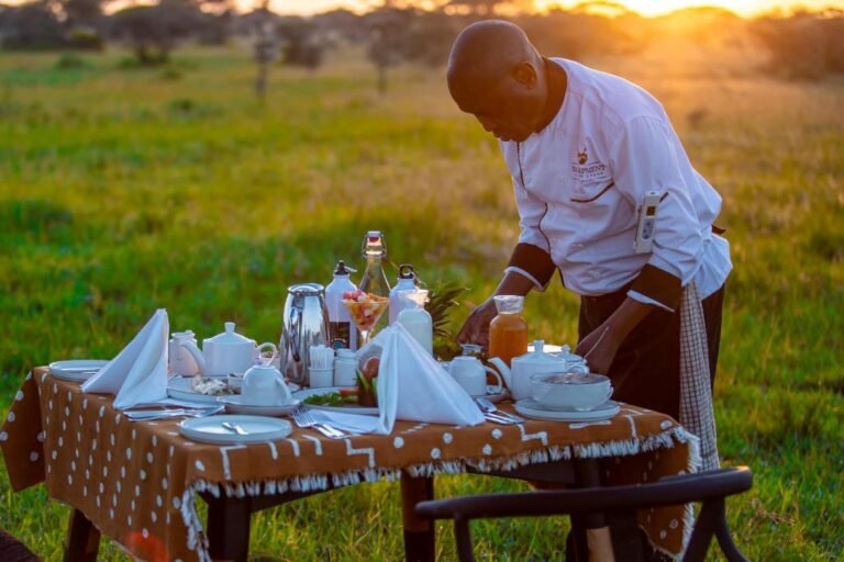 Guests enjoying sunset views from Escarpment Serengeti Luxury Camp terrace