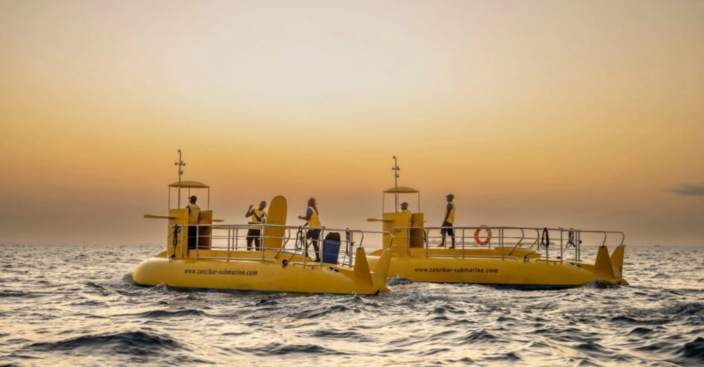 Semi-submarine tour in Zanzibar offering underwater views of coral reefs and colorful tropical fish through panoramic viewing windows.